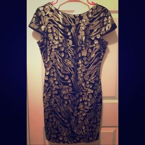 Black and gold mini dress with open back
